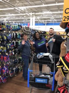 Three team members shoppoing for Angel Tree gifts