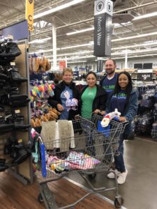 Team members smiling as they buy Angel Tree gifts