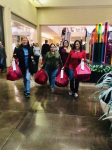 Happy Holidays from Our Home Tax Solutions Family to Yours 7 Team members with bags of Angel Tree gifts