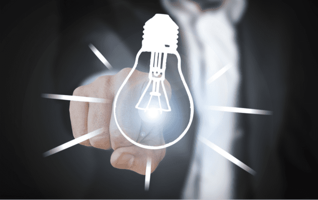 A man in a suit points directly at the viewer. The tip of his find shines like a light. A lightbulb graphic is in front of the finger. The light on the finger makes it seem that the lightbulb is lit.
