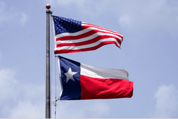 Flag pole with the USA flag above the Texas flag on the Navigating Texas Property Appraisal Protests page